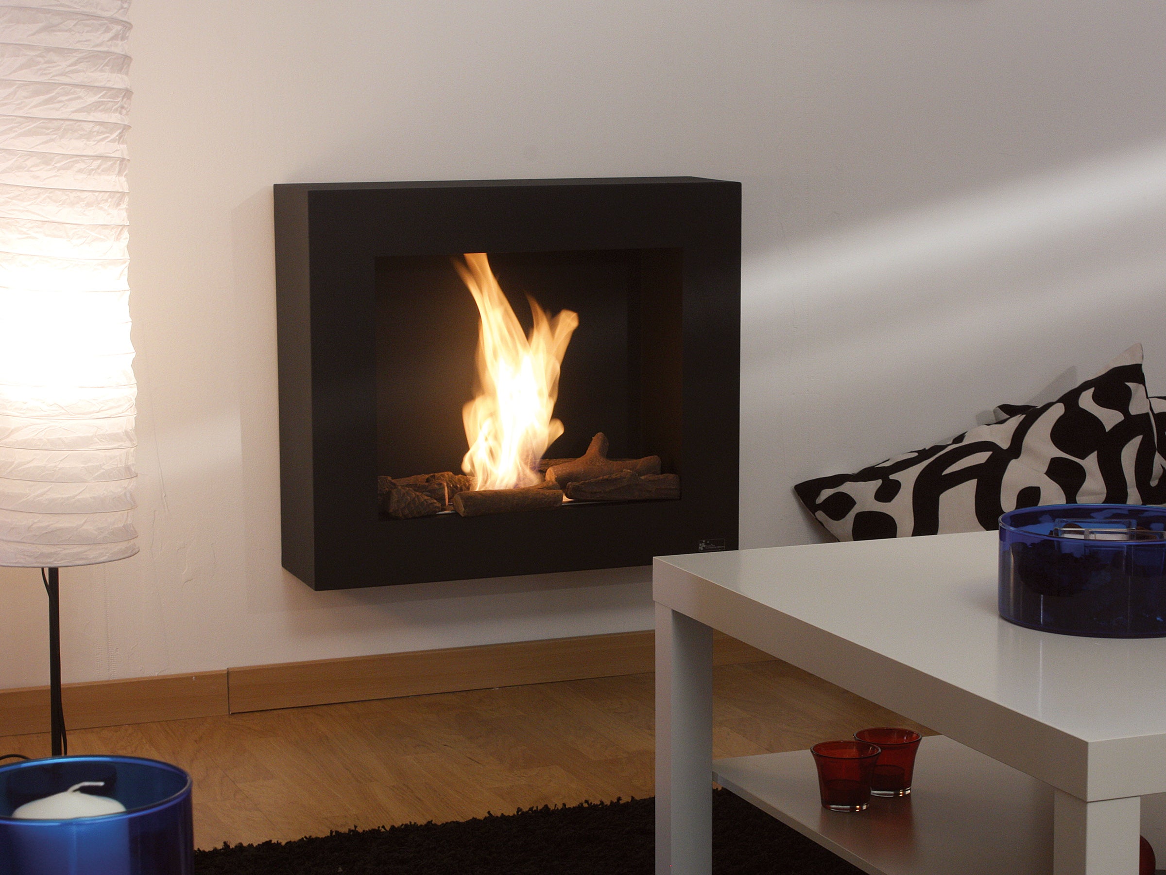 Cheminée à l'éthanol en noir avec des bûches décoratives